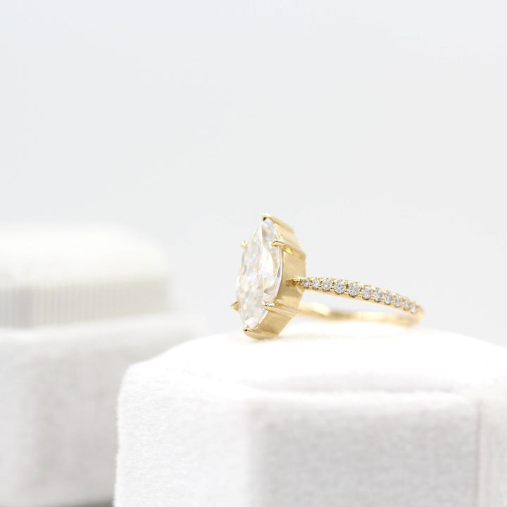 Maisie ring (marquise) in yellow gold on top of a white velvet ring box