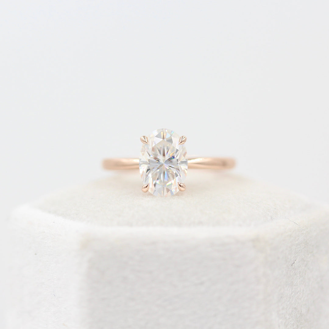 The Margot Ring (Oval) in Rose Gold atop a white velvet ring box