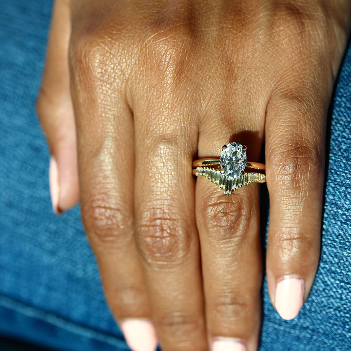 The Margot Ring (Oval) in Yellow Gold stacked with the Darby wedding band in yellow gold modeled on a hand