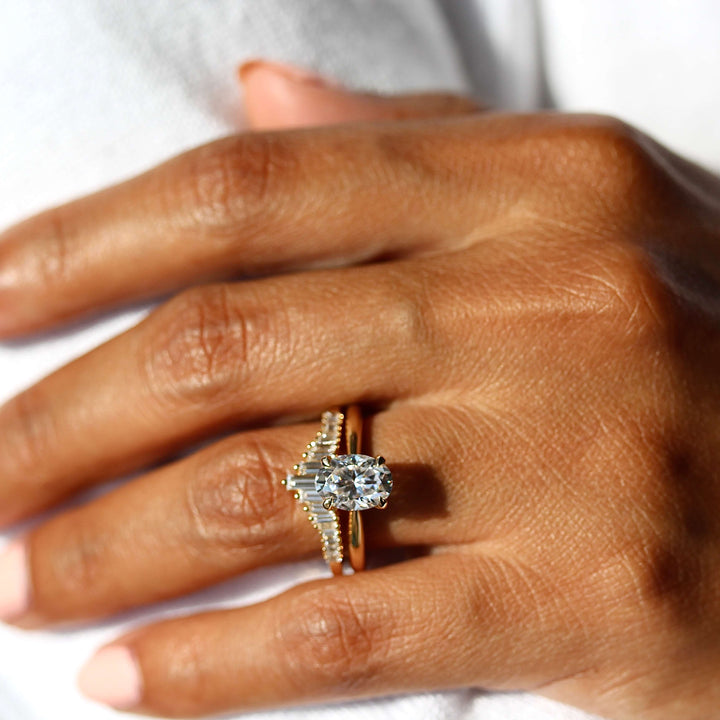 The Margot Ring (Oval) in Yellow Gold stacked with the Darby wedding band in yellow gold modeled on a hand