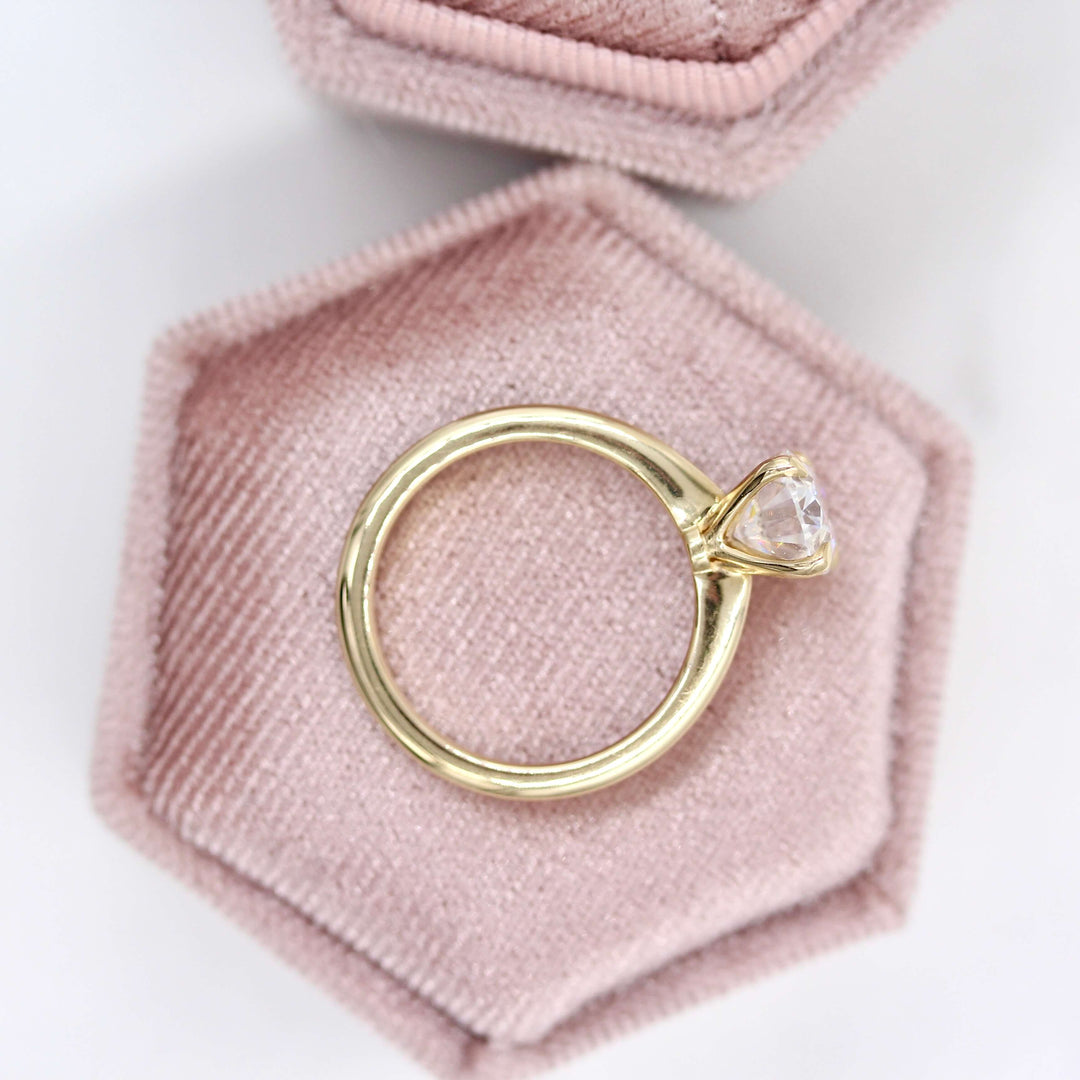 The Margot Ring (Oval) in yellow gold in a velvet ring box