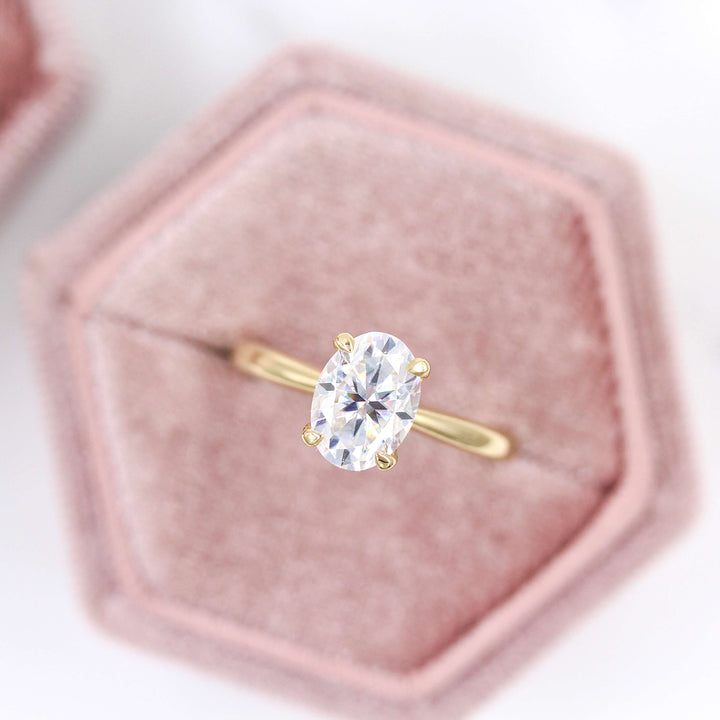 The Margot Ring (Oval) in yellow gold in a velvet ring box