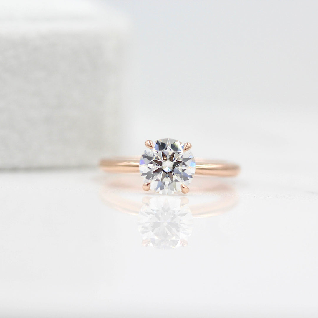 The Margot ring (round) in rose gold against a white background