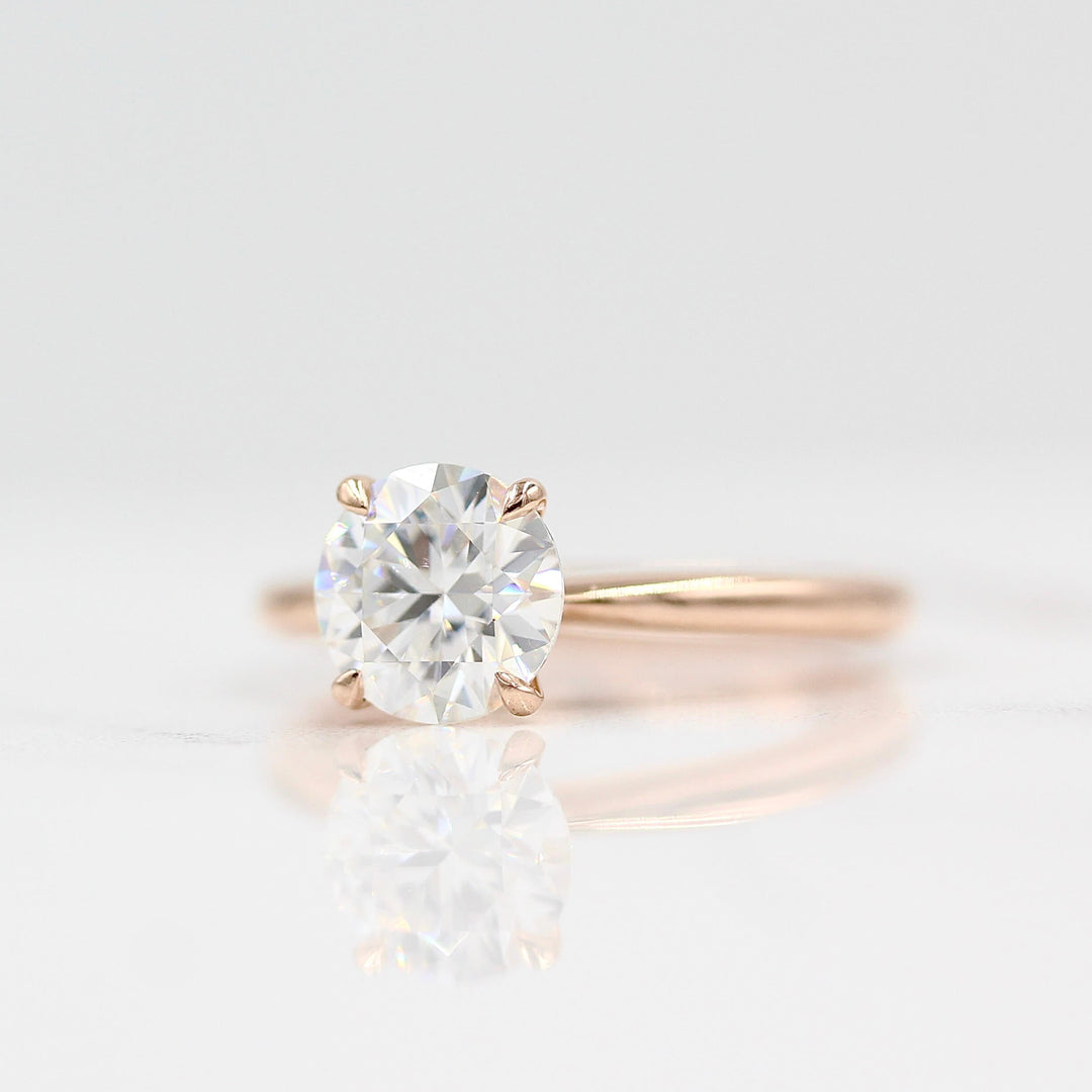 The Margot ring (round) in rose gold against a white background