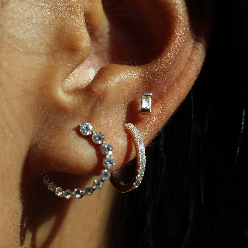 Mix of lab grown diamond earrings worn together
