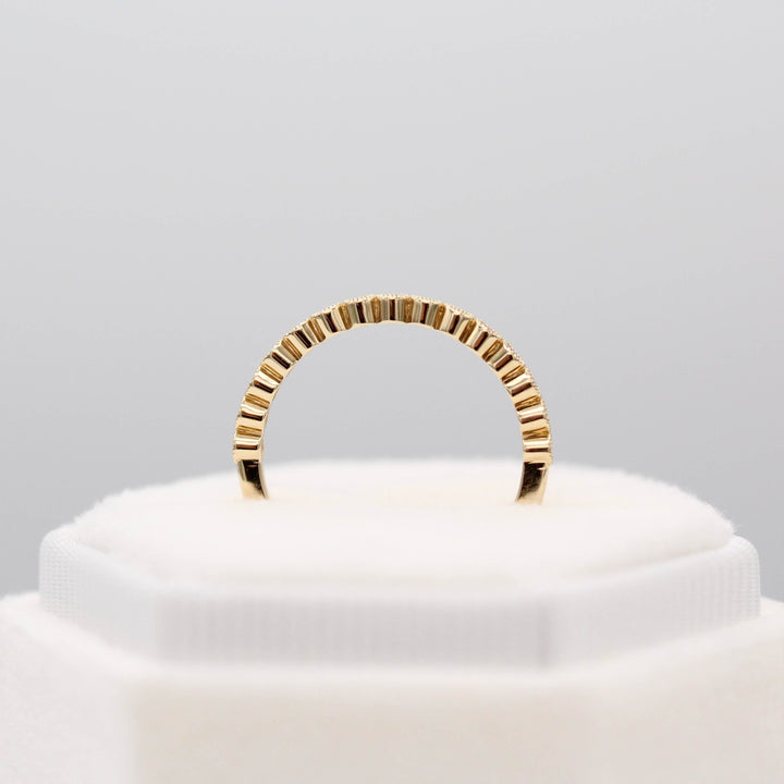 The January Florence Birthstone Wedding Band with Padparadscha Sapphire in Yellow Gold in a white velvet ring box