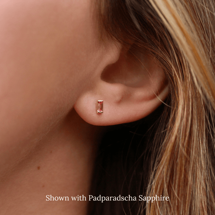 The January Baguette Birthstone Earrings with Padparadscha Sapphire in Yellow Gold modeled