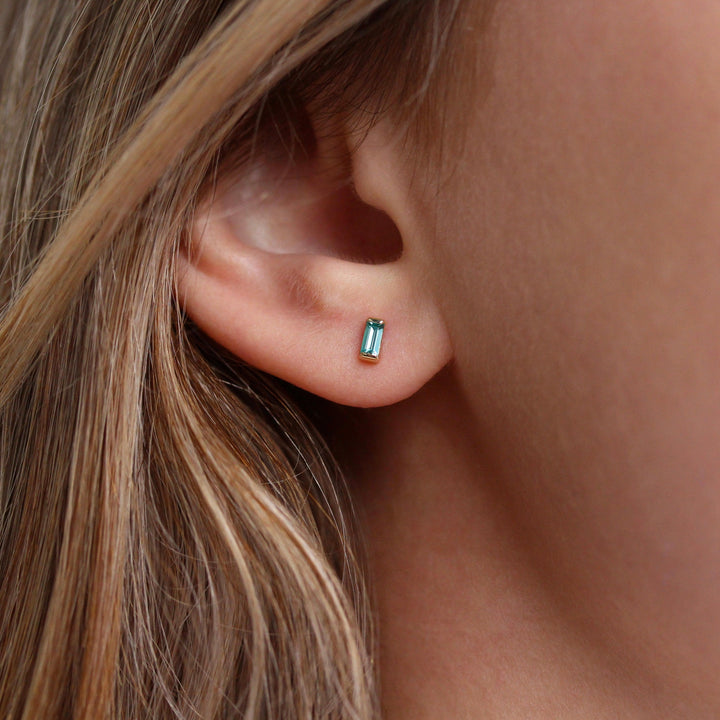 The December Birthstone Baguette Earrings with Paraiba Spinel in Yellow Gold modeled
