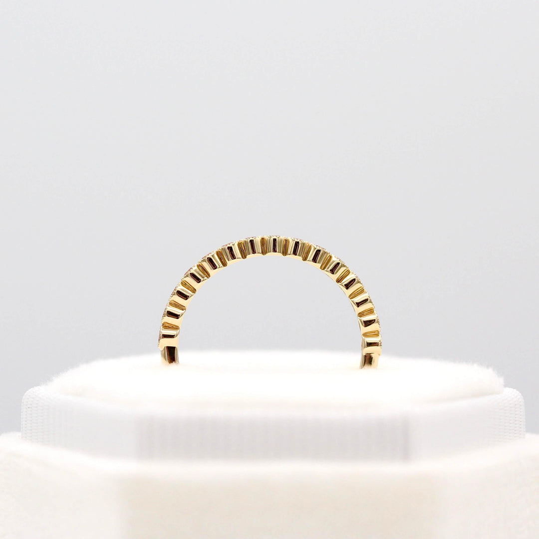 The October Florence Birthstone Wedding Band with Peachy-Pink Sapphire in Yellow Gold in a white velvet ring box