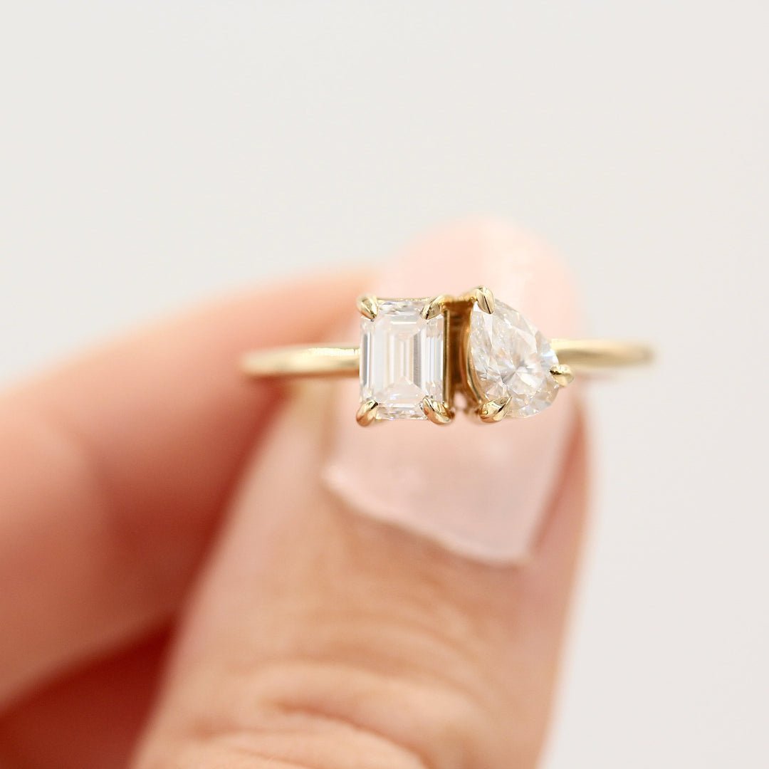 Two stone ring in yellow gold on finger