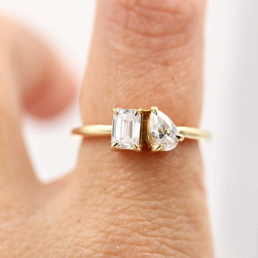 Two stone ring in yellow gold on finger