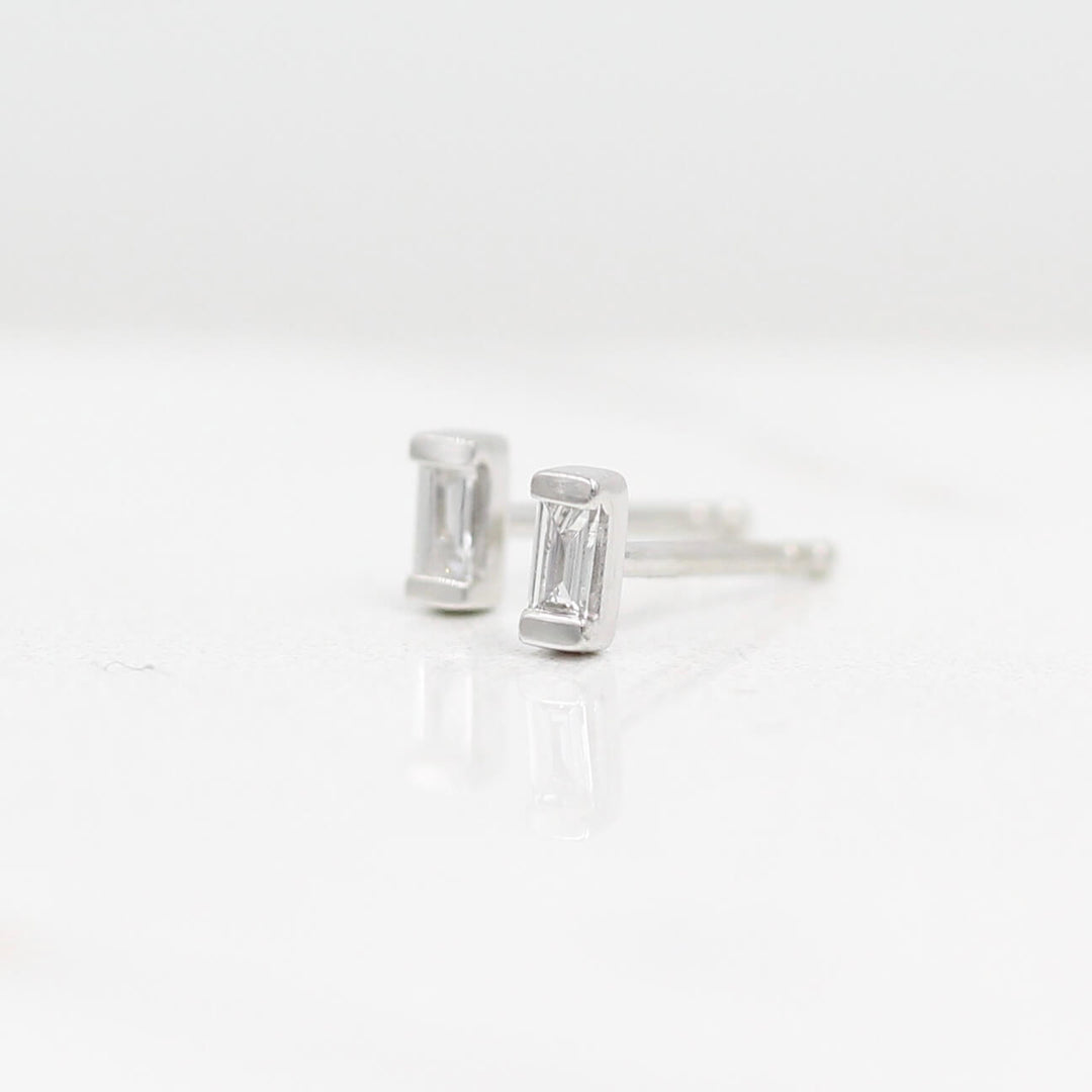 Petite Baguette Earrings in White Gold against a white background