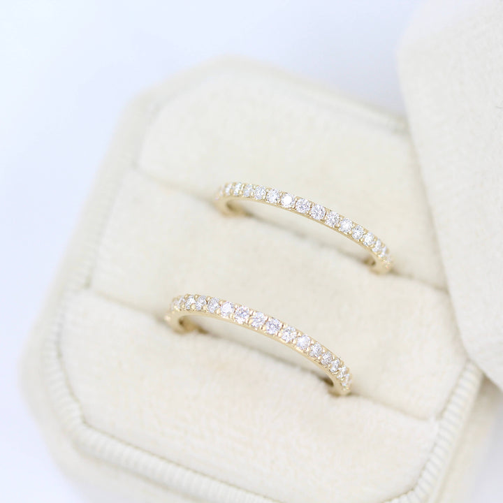 The Petite Elizabeth Wedding Band in Yellow Gold and the Elizabeth Wedding Band in Yellow Gold inside of a white velvet ring box