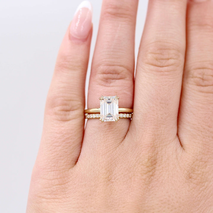 The Petite Elizabeth Wedding Band in Yellow Gold modeled on a hand stacked with the Emerald Serena Ring in Yellow Gold