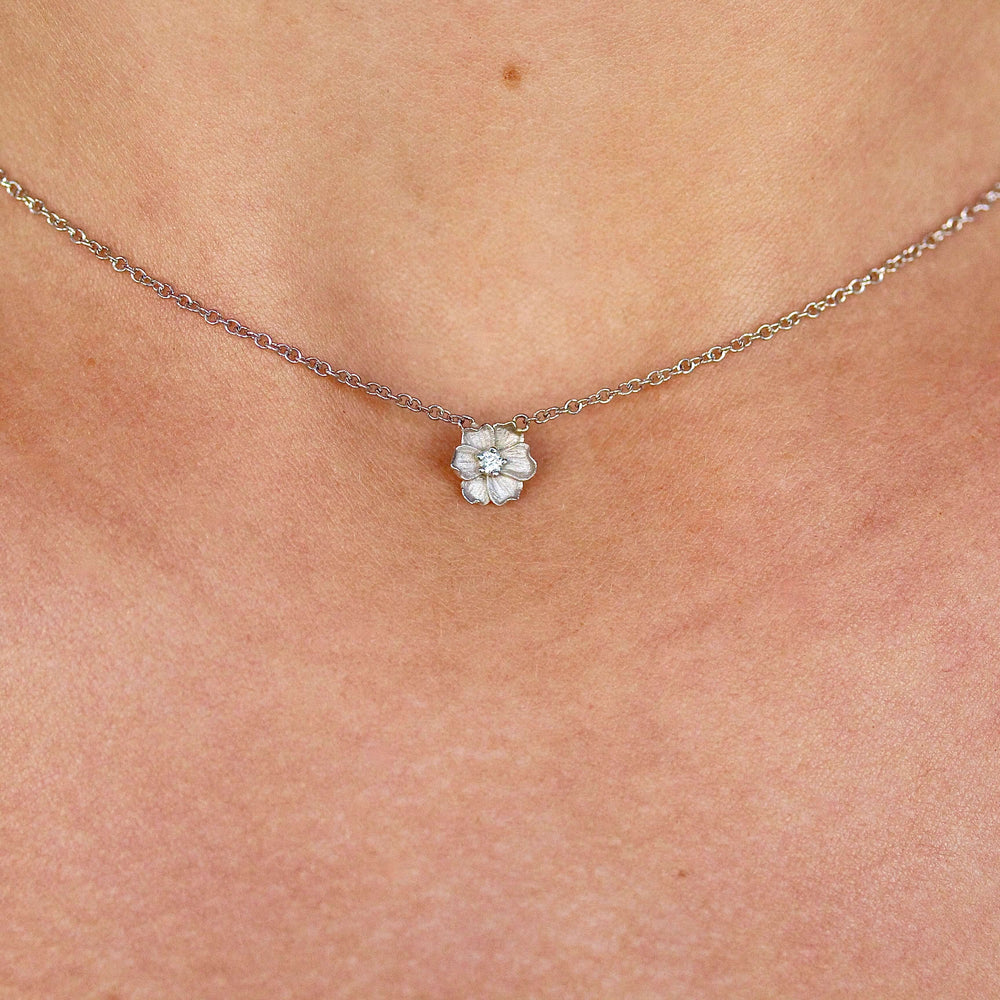 The Poppy Necklace in White Gold modeled on a neck