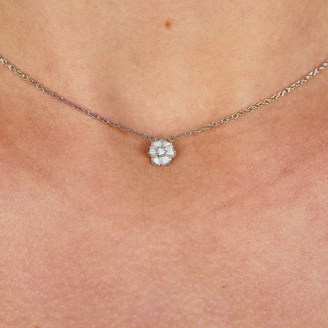 The Poppy Necklace in White Gold modeled on a neck
