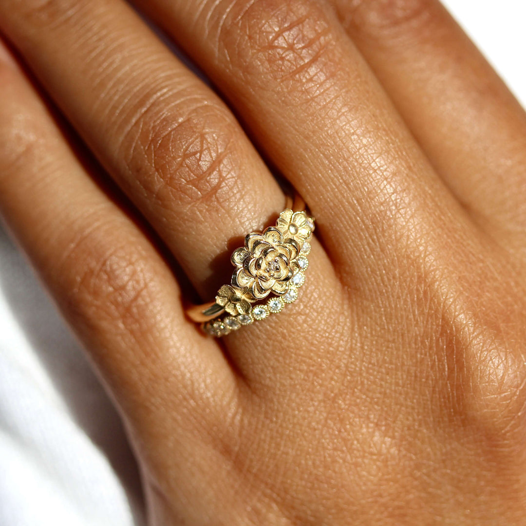 The Posy Ring in Yellow Gold stacked with the Florence Contour wedding band in yellow gold modeled on a hand