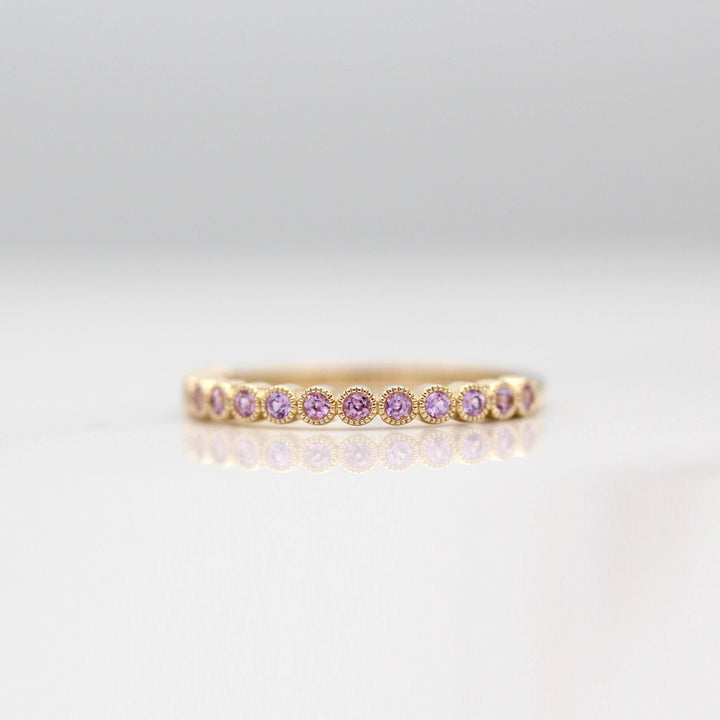 The February Florence Birthstone Wedding Band with Purple Sapphire in Yellow Gold against a white background