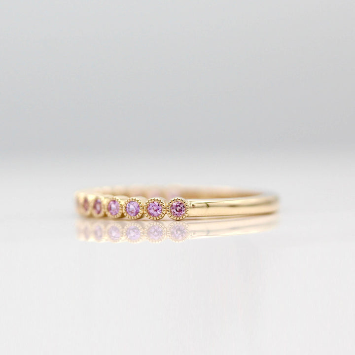 The February Florence Birthstone Wedding Band with Purple Sapphire in Yellow Gold against a white background