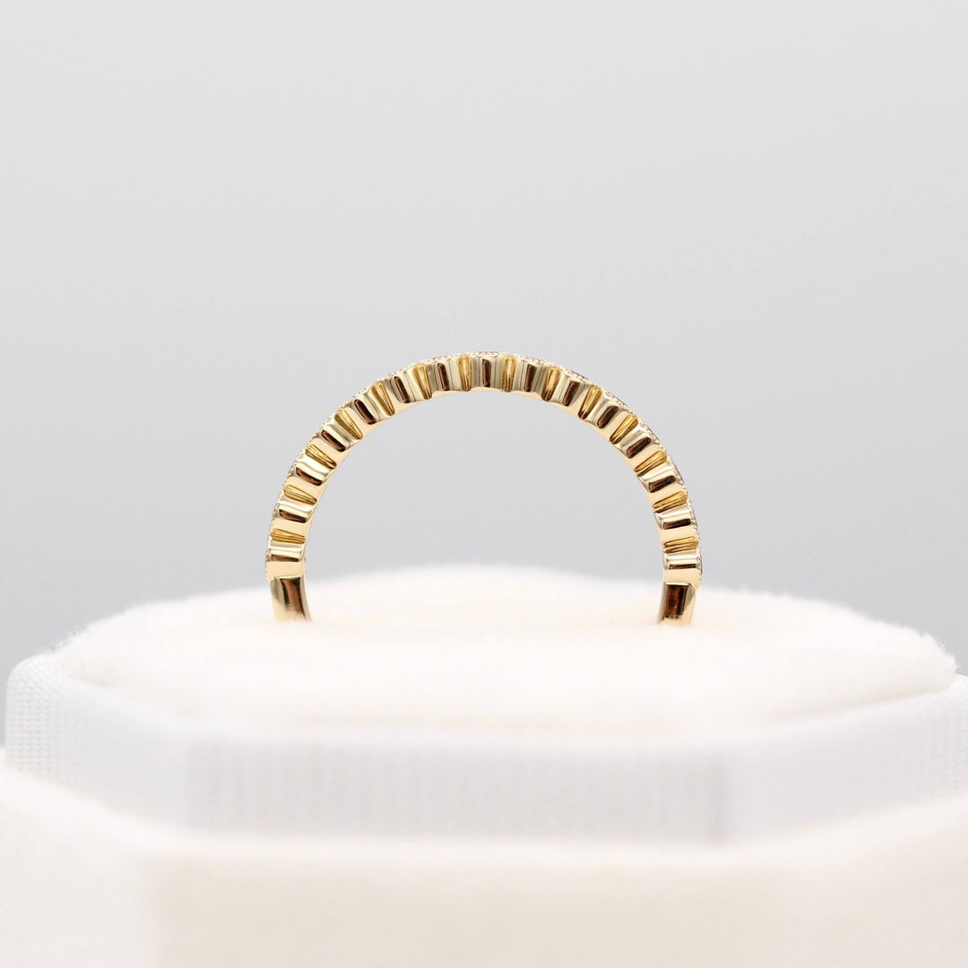 The February Florence Birthstone Wedding Band with Purple Sapphire in Yellow Gold in a white velvet ring box