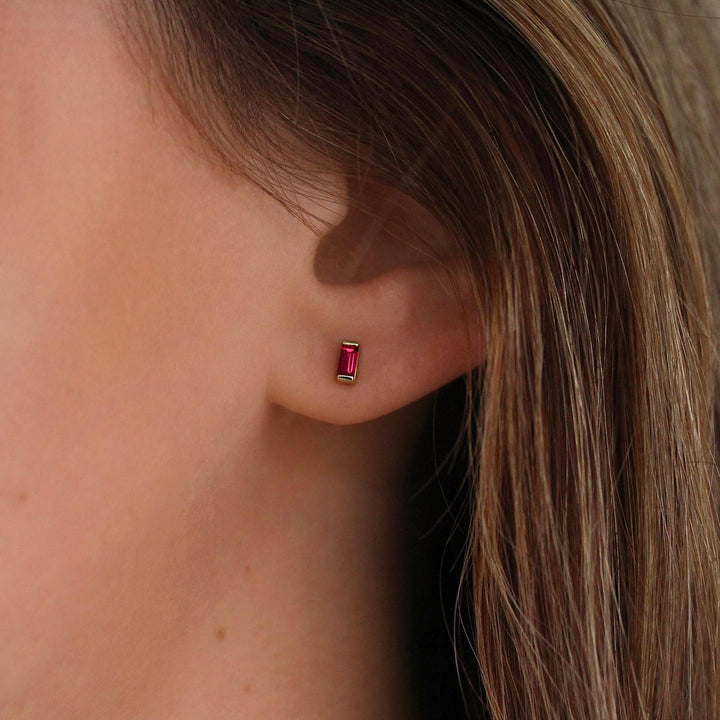 The July Baguette Birthstone Earrings with Ruby in Yellow Gold modeled