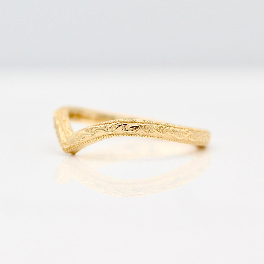 An angled view of the V Shape Wedding Band with Intricate Milgrain and Engraving details.