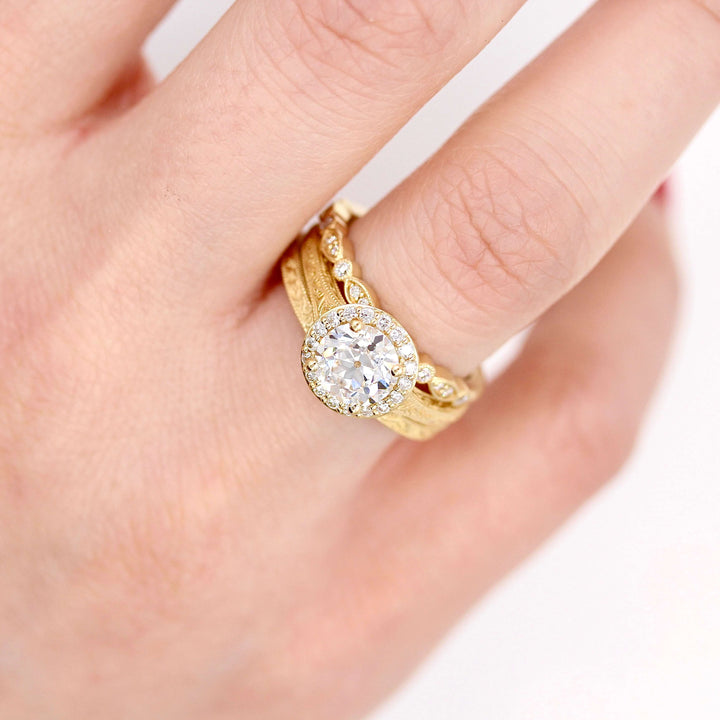 The Sabrina Ring in yellow gold stacked with the Sabrina and Charlotte wedding bands in yellow gold modeled on a hand