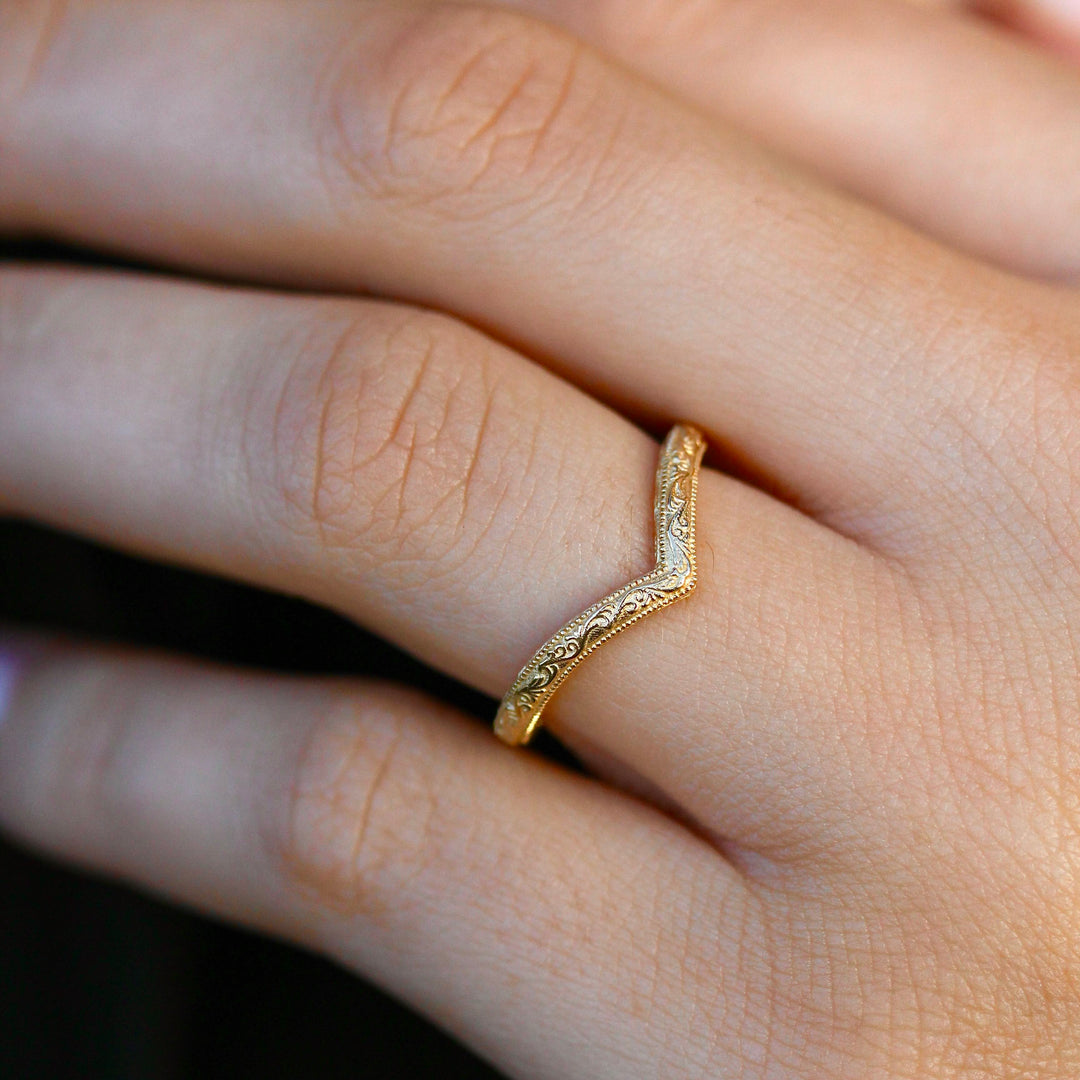 Textured V Wedding Band in Yellow Gold on a Hand