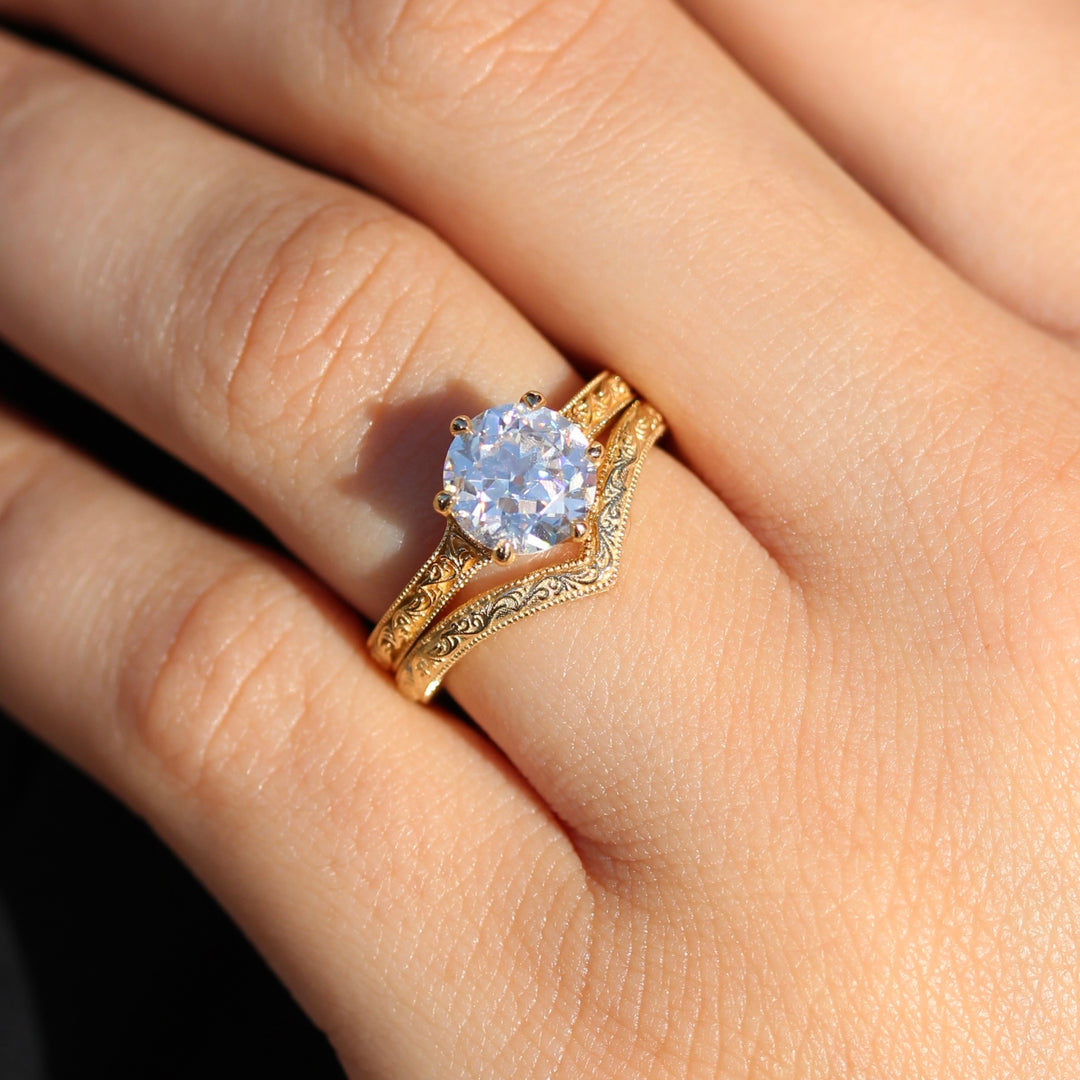 The Sabrina V Wedding Band stack with The Sabrina Engagement Ring (Round) on a Glowy Hand