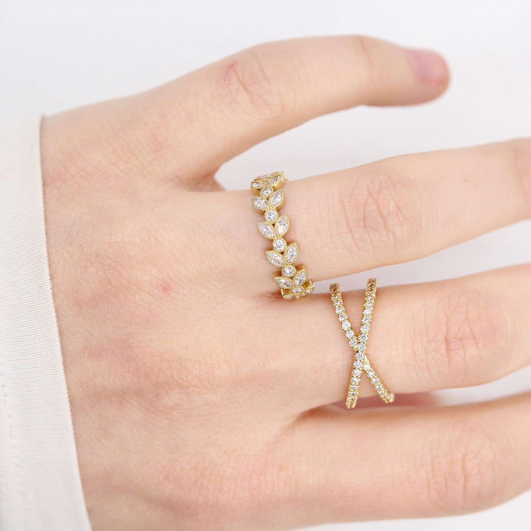 The Salimata Ring in Yellow Gold modeled on a hand with the Criss-Cross ring in yellow gold