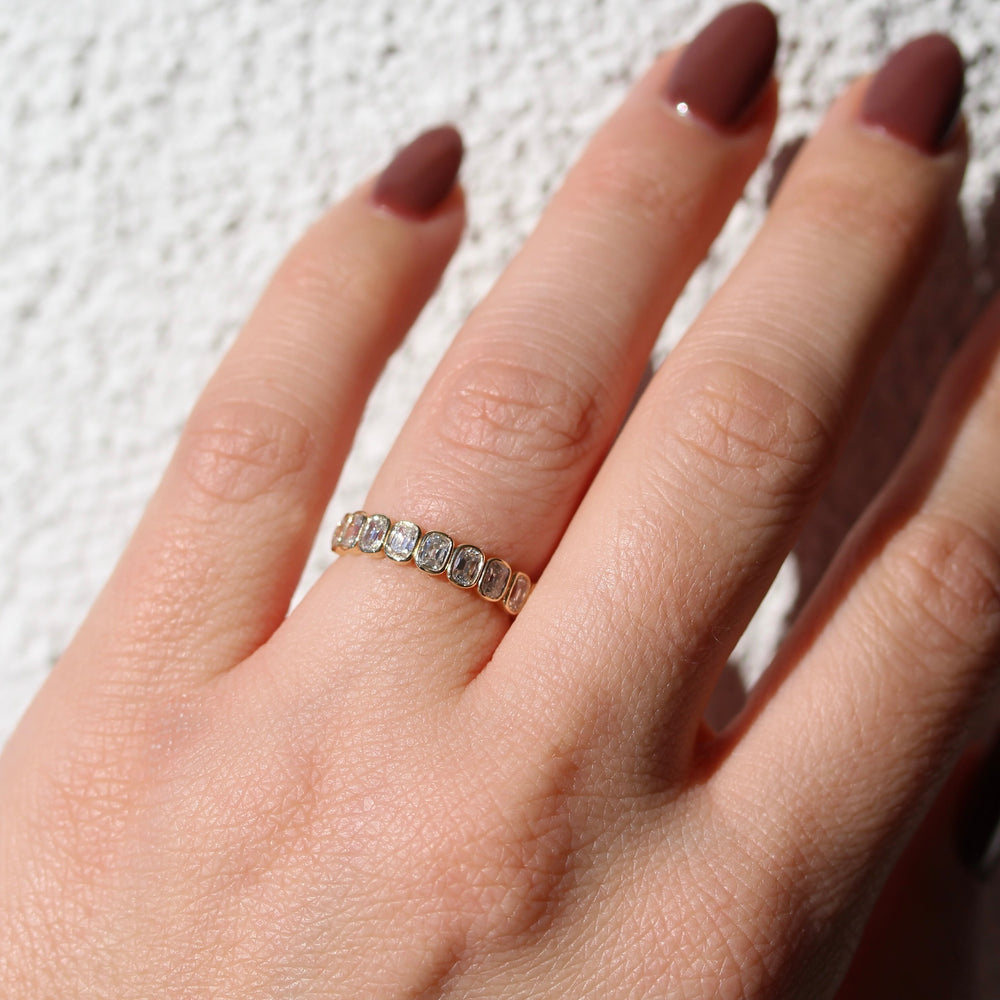 Old Miner Bezel set Wedding Band on a Glowy Hand.