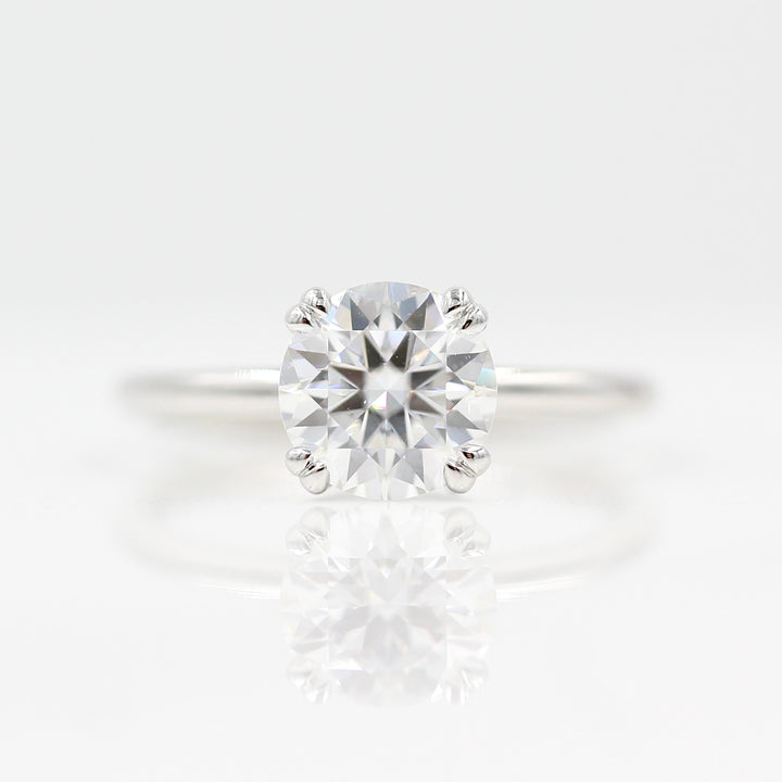 The Serena Ring (Round) in White Gold with 1.5ct Moissanite against a white background