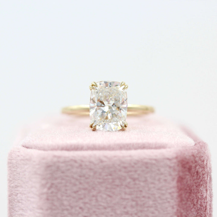 The Serena Ring (Elongated Cushion) in Yellow Gold with 3.06ct Lab-Grown Diamond atop of a pink velvet ring box