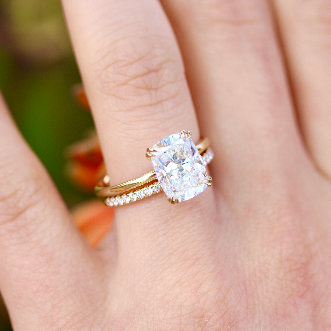 The Lauryn Wedding Band in Yellow Gold stacked with the Serena Ring in Yellow Gold with a 3ct Elongated Cushion Lab-Grown Diamond modeled