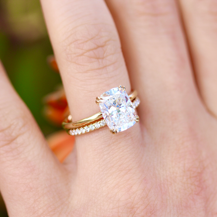 The Lauryn Wedding Band in Yellow Gold stacked with the Serena Ring in Yellow Gold with a 3ct Elongated Cushion Lab-Grown Diamond modeled