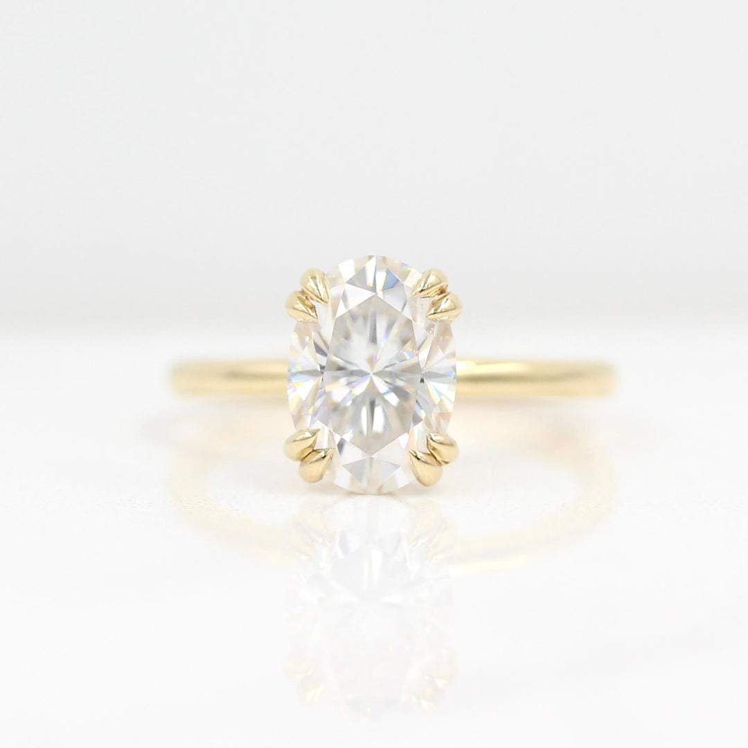 The Serena Ring (Oval) in Yellow Gold and 2ct Moissanite against a white background