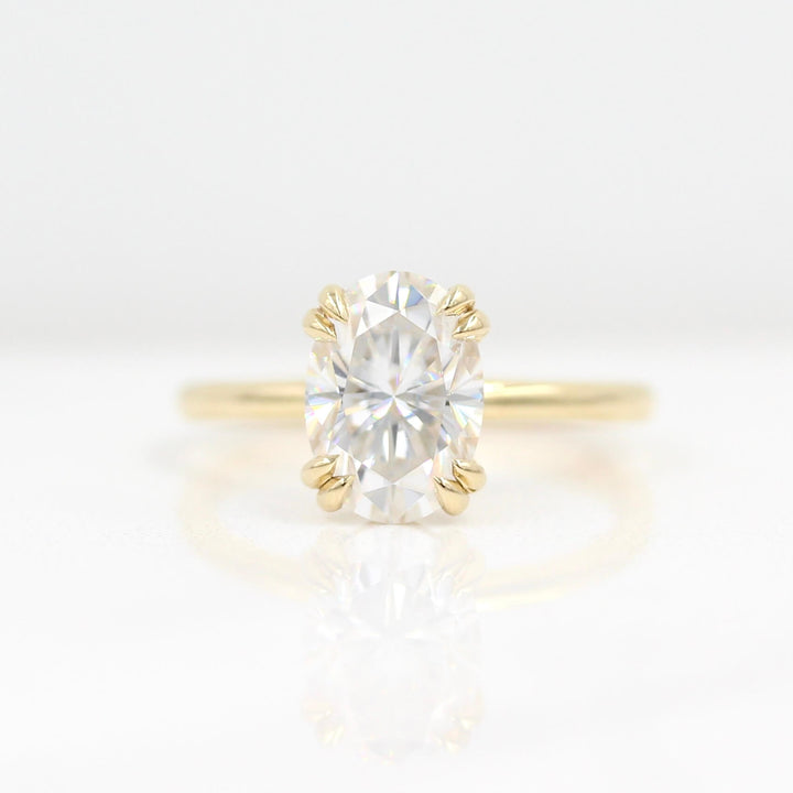 The Serena Ring (Oval) in Yellow Gold and 2ct Moissanite against a white background
