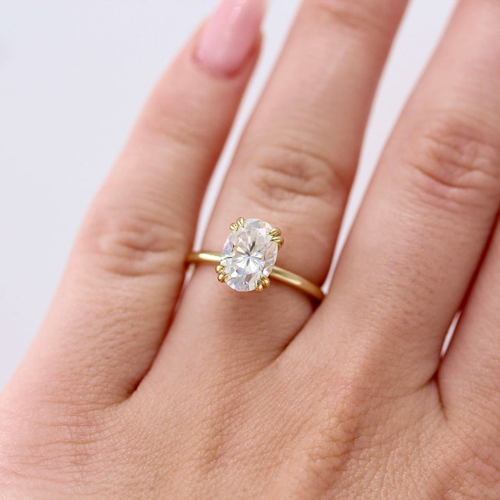 The Serena Ring (Oval) in Yellow Gold and 2ct Moissanite modeled on a hand