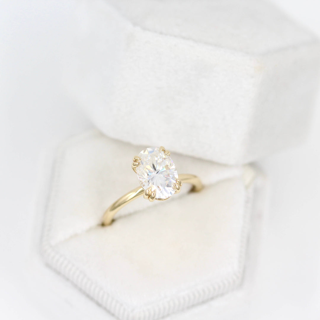 The Serena Ring (Oval) in Yellow Gold and 2ct Moissanite in a white velvet ring box