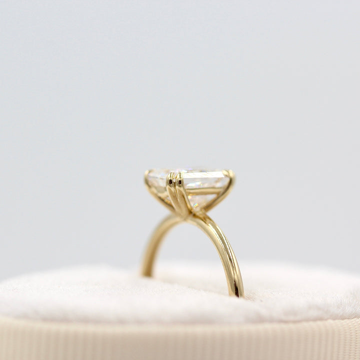 The serena radiant in yellow gold in a white velvet ring box