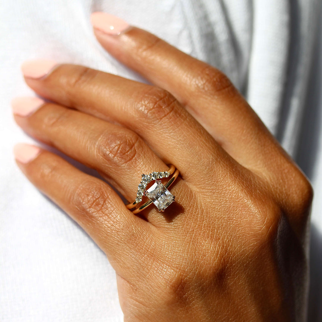 The Serena Ring (Radiant) in Yellow Gold stacked with the Tiara wedding band in yellow gold modeled on a hand