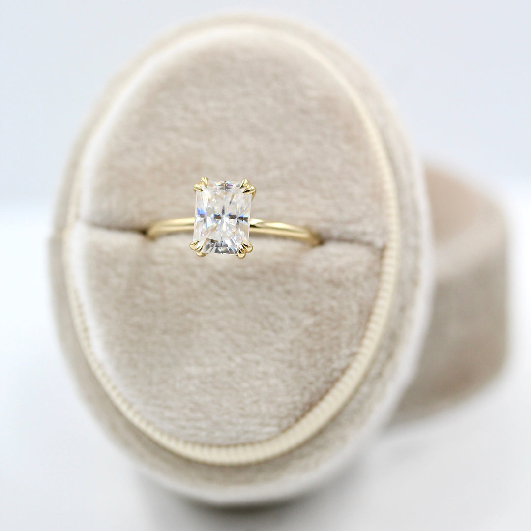 The serena radiant in yellow gold in a white velvet ring box