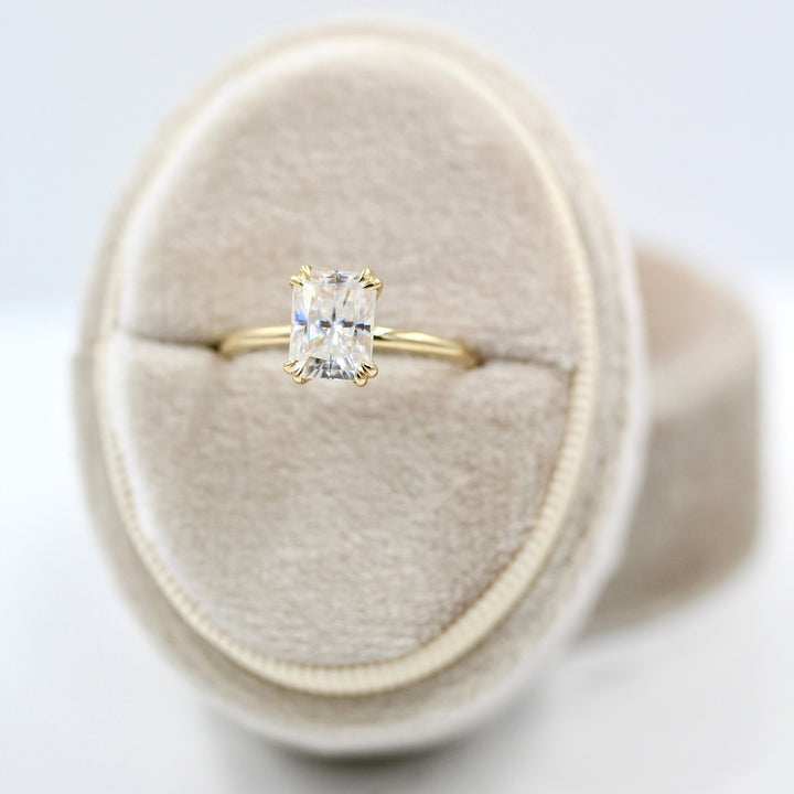 The serena radiant in yellow gold in a white velvet ring box