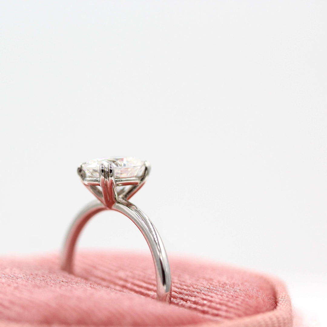 The Serena ring round in white gold in a pink velvet ring box
