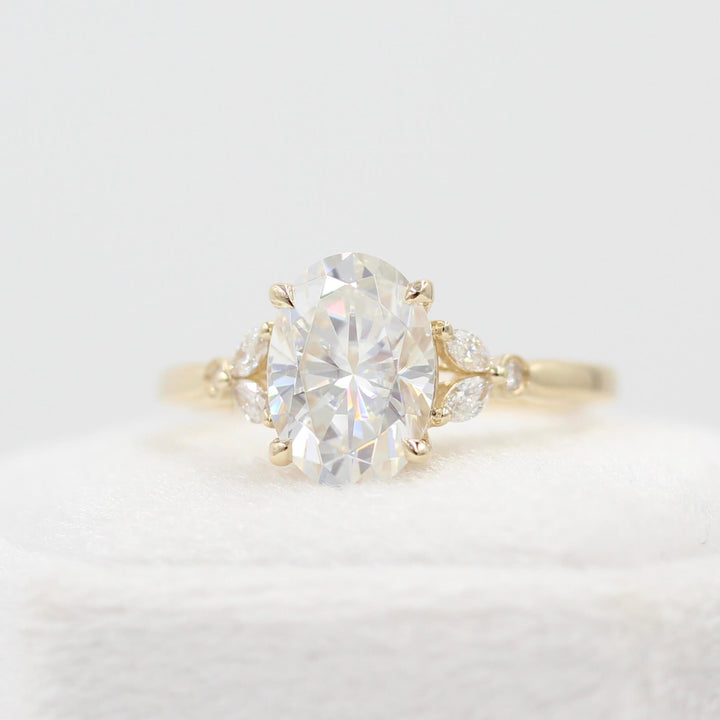 The Sophia Ring (Oval) in Yellow Gold and 2ct Moissanite atop a white velvet ring box