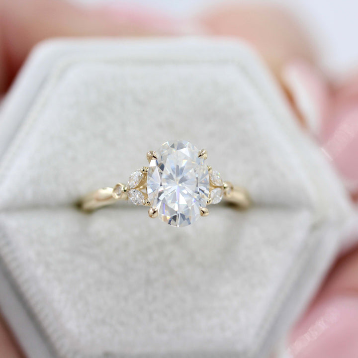 Ready to Ship Ring 14k Yellow Gold The Sophia Ring (Oval) in Yellow Gold with 2ct Moissanite in a white velvet ring box held by a hand