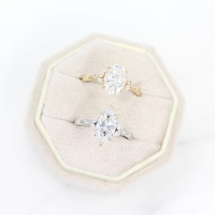 The Sophia Ring (Oval) in Yellow Gold and 2ct Moissanite in a white velvet ring box with the Sophia Ring (Marquise) in White Gold and Lab-Grown Diamond