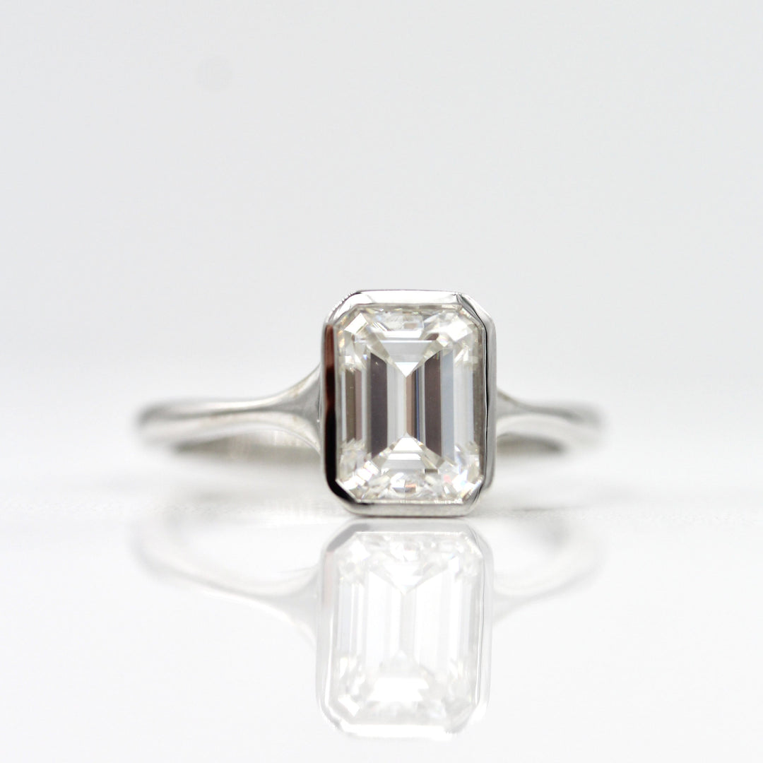 Emerald cut moissanite bezel engagement ring