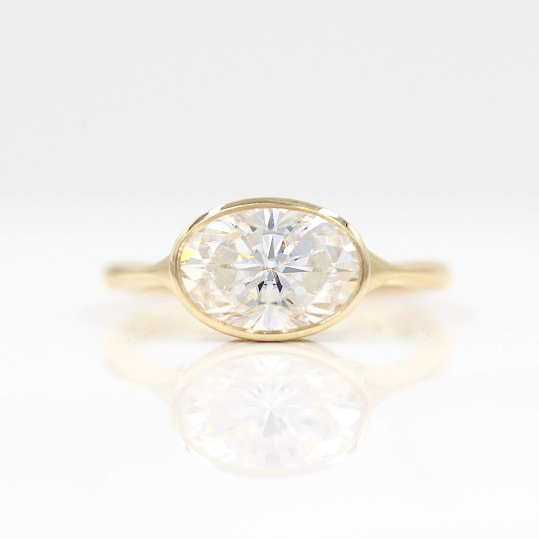 The Stevie Ring (east-west oval) in yellow gold against a white background