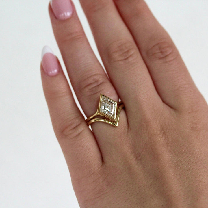 The Deep V Wedding Band in Yellow Gold stacked with the Stevie Ring in Yellow Gold with a 2ct Lozenge Lab-Grown Diamond modeled